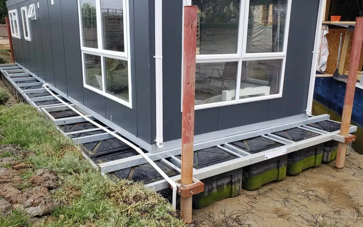 Self-build floating home under construction on a modular pontoon base