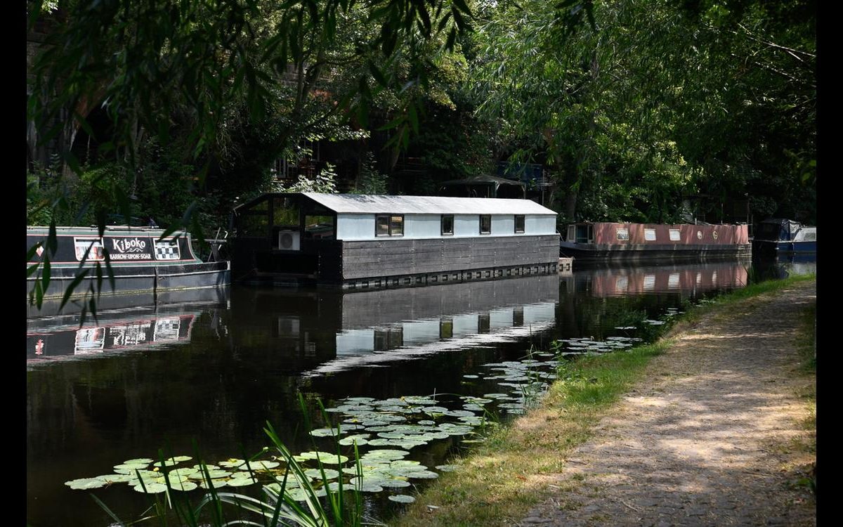 The Charnwood Ark navigable trimaran houseboat on an inland waterway